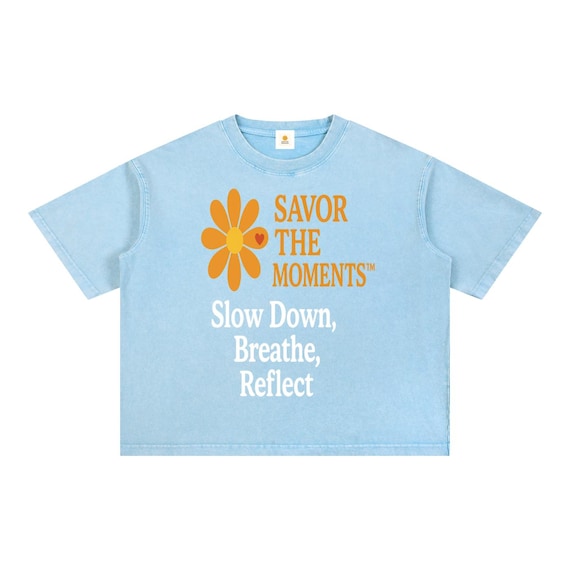 Relaxed mineral wash boxy tee featuring wellness vibe, happy saying, savor the moments message, breathe, reflect, and orange daisy art.