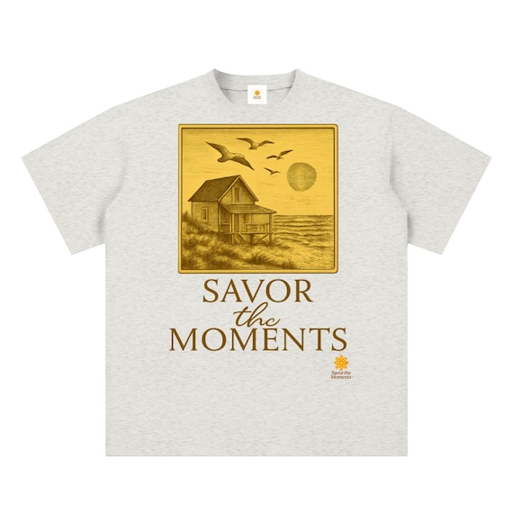 Unisex sueded cotton t‑shirt, a peaceful coastal vibe, inspired by ocean breezes, seagulls, soft sunset colors. Savor the Moments TM
