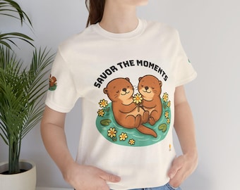 Cute Otter Pair T‑Shirt • Otters Holding Yellow Daisy • Water & Lily Pads Illustration • Nature Inspired Graphic Tee