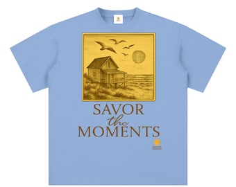 Unisex sueded cotton t‑shirt, peaceful coastal vibe, ocean breezes, seagulls, soft sunset colors. Savor the Moments TM