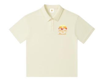 Surfer Drop‑Shoulder Polo • Surfing Sun Graphic Shirt • Beach Style Short‑Sleeve Polo • Coastal Casual Wear