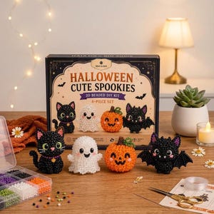May include: A 3D beaded DIY kit titled Halloween Cute Spookies, featuring four finished figures: a black cat, a white ghost, an orange pumpkin, and a black bat. The set includes a storage container with colourful beads, scissors, and clear string.
