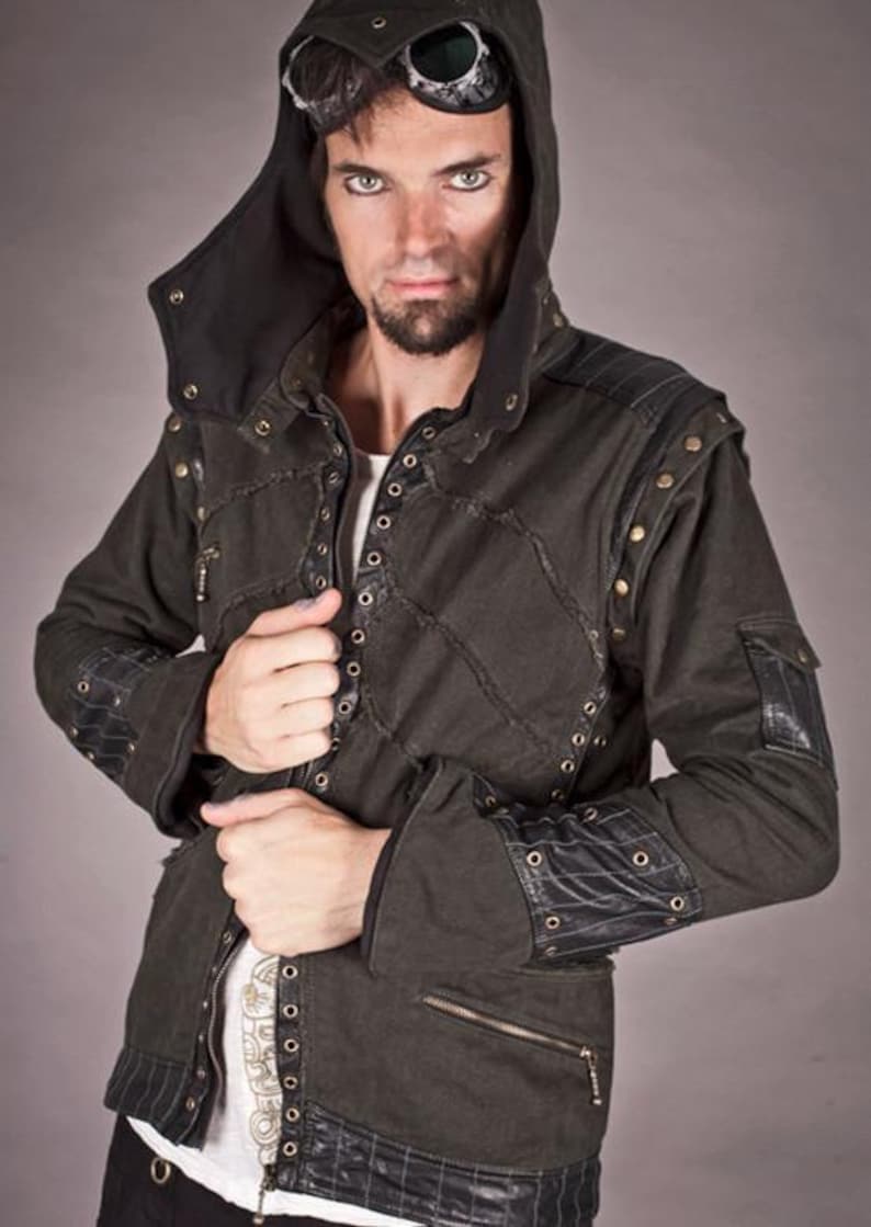 May include: A dark green hooded jacket with black leather accents and silver eyelets. The jacket has a zip fastening and two pockets on the front.
