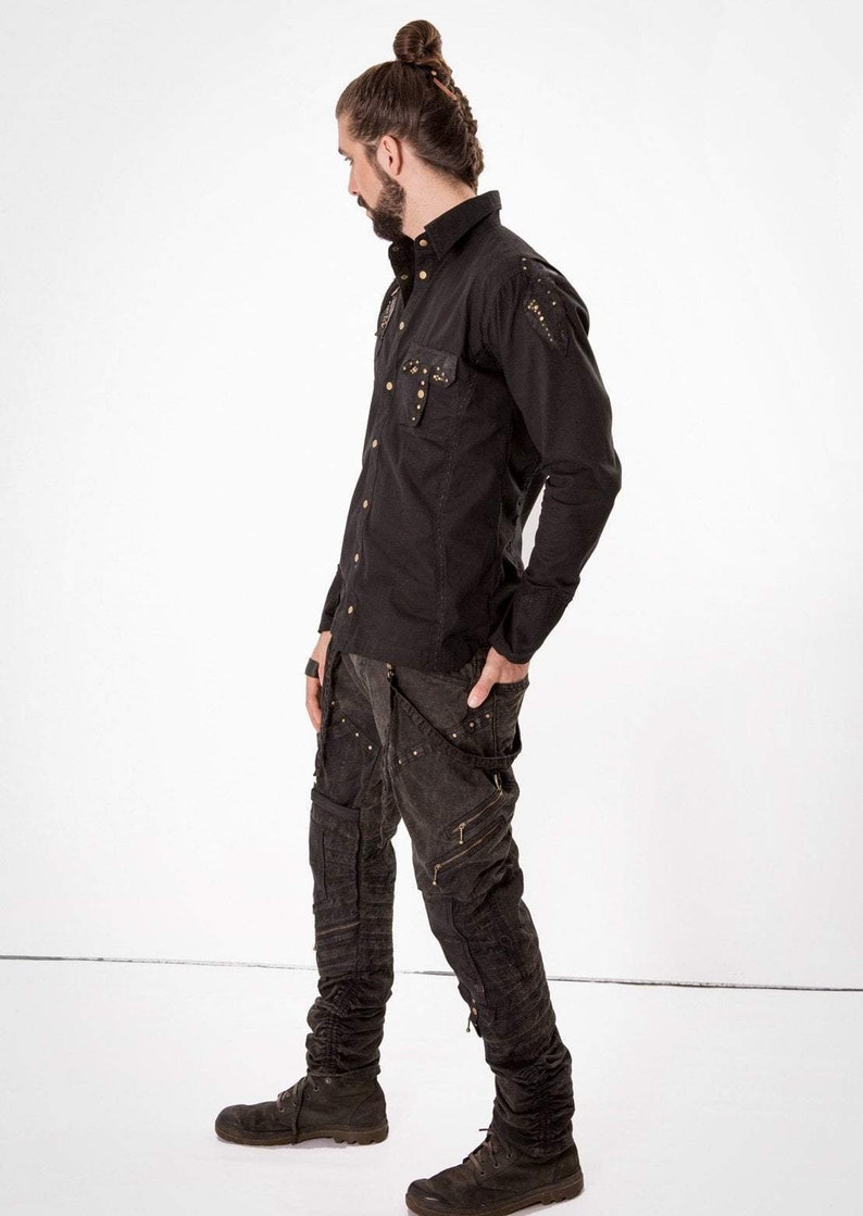 May include: A black long-sleeved shirt with gold studs and a black pair of cargo pants with gold accents.