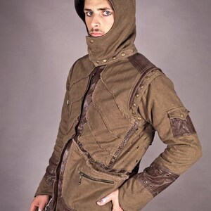 May include: A brown hooded jacket with brown leather accents and metal studs. The jacket has a zip fastening and multiple pockets.