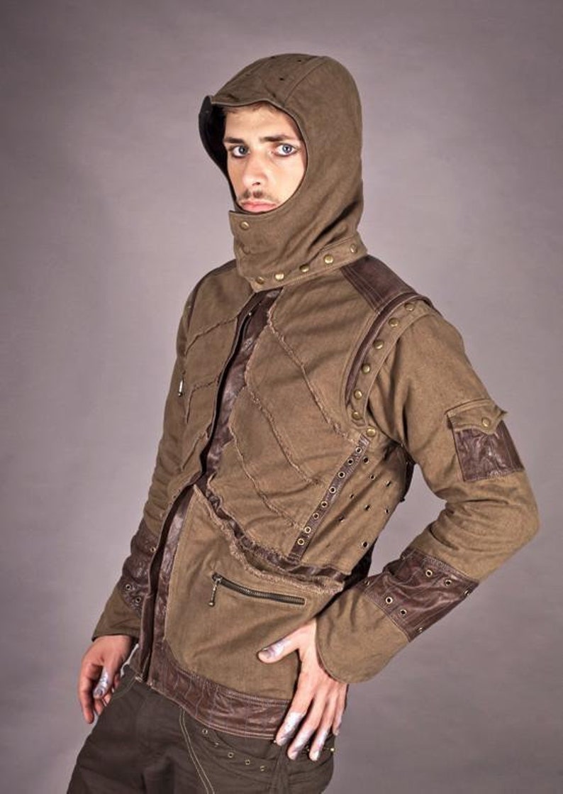 May include: A brown hooded jacket with brown leather accents and metal studs. The jacket has a zip fastening and multiple pockets.