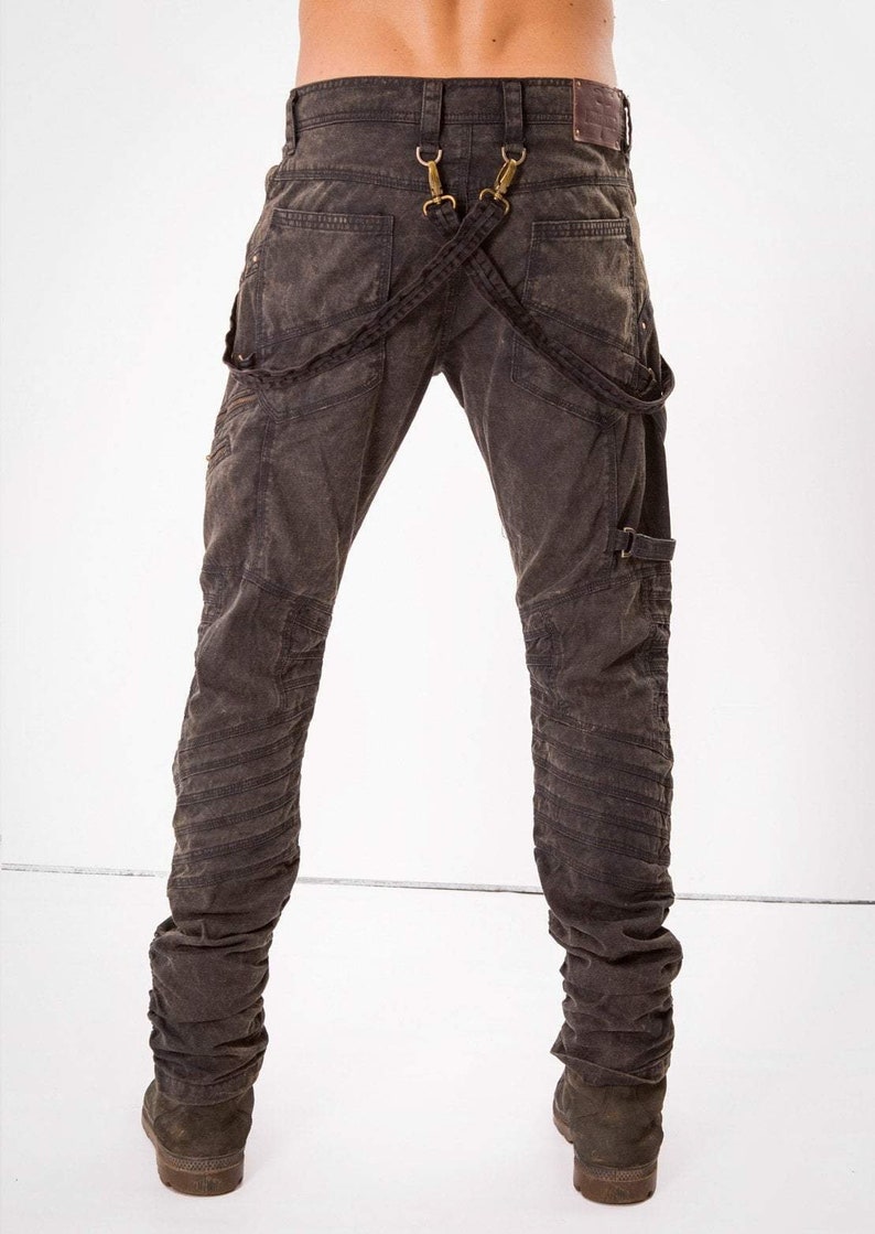 May include: Dark gray denim jeans with multiple stitched panels and a unique suspender system with metal hardware.