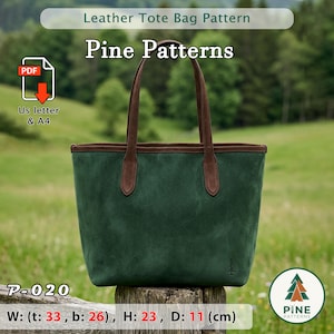 Puede incluir: Bolso tote de ante verde con asas y ribetes de cuero marrón. El bolso tiene un pequeño logotipo de pino y el texto "Pine Patterns". Dimensiones: 33 cm de ancho en la parte superior, 26 cm en la inferior, 23 cm de alto y 11 cm de profundidad.