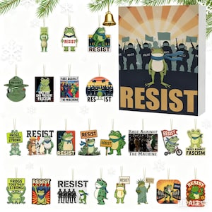 May include: A collection of frog-themed ornaments and a box featuring the word "RESIST". The ornaments display various frog illustrations with messages like "RESIST", "Frogs Together Strong", and "Rage Against The Machine".