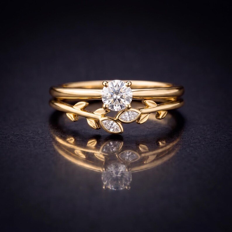 May include: A gold ring set featuring a central round brilliant-cut diamond and a secondary band adorned with marquise-cut diamonds arranged in a leaf-like pattern. The polished gold bands create a cohesive design with clear gemstone accents.