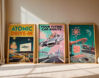 May include: Three framed posters featuring retro-futuristic art. The left poster shows an Atomic Drive-In with a flying saucer. The center poster displays a family in a flying car with the text Your Flying Car Awaits. The right poster depicts a Moon Motel.