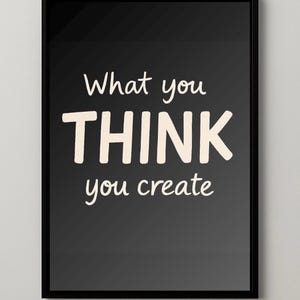 Puede incluir: Impresión enmarcada en negro con el texto "What you THINK you create" en blanco, con una fuente manuscrita. La impresión tiene un fondo gris oscuro.