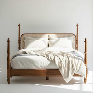 May include: A wooden four-poster bed with a light-coloured headboard and footboard. The bed is made up with white bedding, including pillows and a blanket. The bed frame is a warm brown colour, and the overall aesthetic is minimalist and inviting.