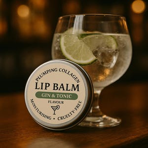 May include: A silver lip balm tin with the words "Lip Balm" and "Gin & Tonic" printed on it, next to a gin and tonic with a lime slice. The lip balm is moisturising and cruelty-free, with plumping collagen.