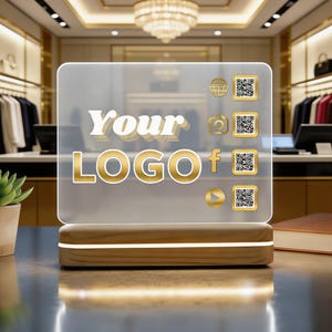 May include: A clear acrylic sign with the words "Your LOGO" in gold lettering. The sign has a wooden base with a warm light. Social media icons and QR codes are displayed on the right side.