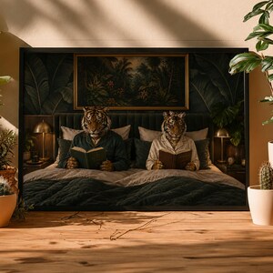 May include: A framed wall art print depicting two anthropomorphic tigers with human bodies sitting in a bed, each reading a book. The scene features a dark green upholstered headboard, bedside lamps, and a jungle-themed painting above the bed.
