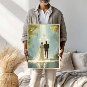 May include: A framed art print depicting a wedding scene. The artwork shows a couple in formal attire standing before a figure in white light. The background features a serene landscape with trees and water, rendered in soft, pastel colors.