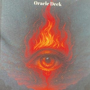May include: An oracle deck titled "Twin Flames" with an illustration of a fiery eye. The eye is surrounded by flames in shades of red and orange against a dark grey background. The author's name, Samantha Jones, LPCC-S, is at the bottom.