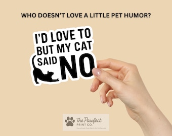 Può includere: Un adesivo con la scritta "I'D LOVE TO BUT MY CAT SAID NO" e un'illustrazione di un gatto nero. L'adesivo è tenuto da una mano su uno sfondo beige. Il logo The Pawfect Print Co. è in basso.