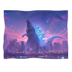 May include: A blanket featuring a digital illustration of Godzilla towering over a city skyline. The artwork showcases a vibrant color palette of purples, blues, and pinks, with the monster's dorsal fins glowing. The blanket is rectangular.