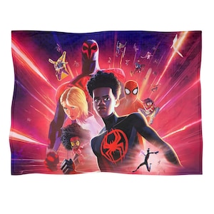 May include: A rectangular blanket featuring a vibrant illustration of multiple Spider-Man characters against a red and purple background. The design includes various figures in action poses, with a prominent spider emblem.