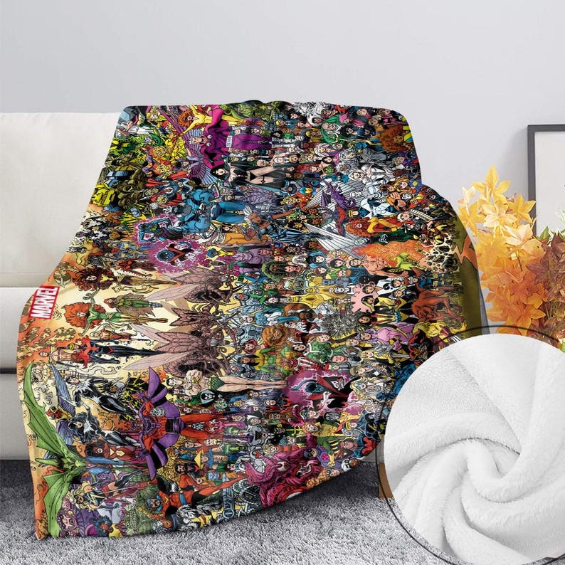 May include: A plush throw blanket featuring a collage of Marvel comic book characters in vibrant colors. The blanket displays a variety of superheroes and villains, with the Marvel logo visible. The blanket is draped over a white couch.