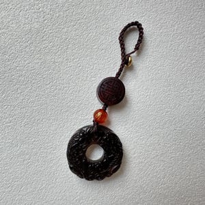 Obsidian Ring Charm: Carved Mythical Beast with Wooden Longevity Bead