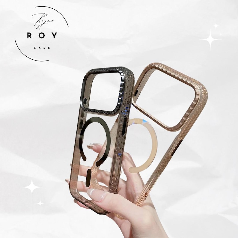 May include: Two clear phone cases with metallic borders. One case has a dark gray border, the other a gold border. Both cases have a circular design on the back. The brand name "ROY CASE" is printed in a circle at the top.