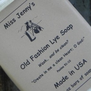 May include: A bar of brown lye soap with the text "Miss Jenny's Old Fashion Lye Soap" and the quote "Create in me a clean Heart: O God:" Psalms 51:10. The soap is made in the USA.