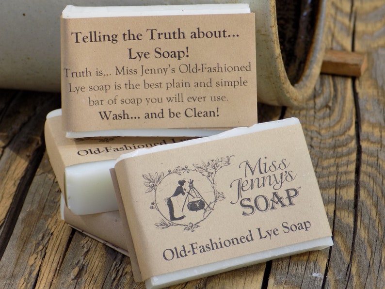 May include: Three bars of white lye soap wrapped in brown paper with a label that reads "Miss Jenny's Soap" and "Old-Fashioned Lye Soap". The top bar has a label that reads "Telling the Truth about... Lye Soap! Truth is... Miss Jenny's Old-Fashioned Lye soap is the best plain and simple bar of soap you will ever use. Wash... and be Clean!"