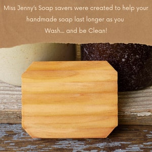 May include: A wooden soap saver with a rounded edge. The soap saver is made of light brown wood and has a natural wood grain. The soap saver is sitting on a wooden surface.