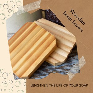 May include: Two wooden soap savers, made of light brown wood, with ridges to help soap last longer. The text "Wooden Soap Savers" and "Lengthen the life of your soap" is visible in the image.