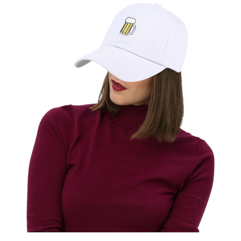 May include: White baseball cap with a curved brim. The cap features a small embroidered design of a beer mug with yellow and black details. The cap is a classic style, suitable for casual wear.