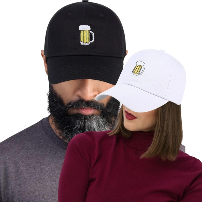 May include: Two baseball caps, one black and one white, each with an embroidered beer mug design. The black cap is worn by a person with a beard, and the white cap is worn by a person with red lipstick.