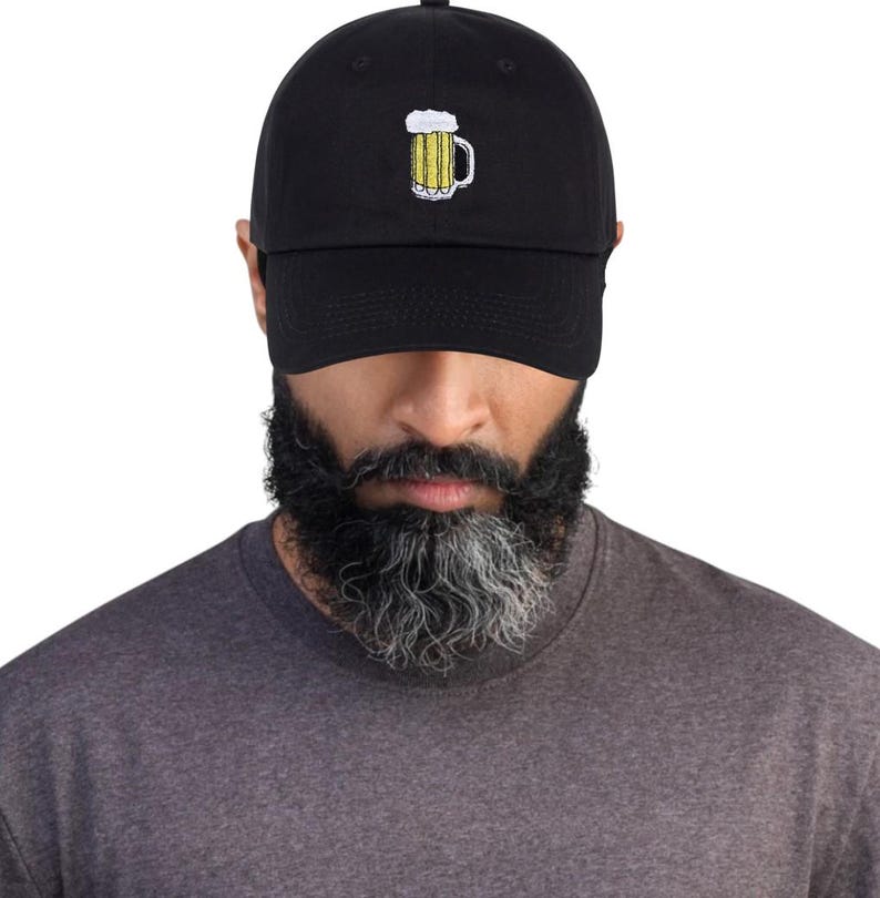 May include: Black baseball cap with a yellow and white embroidered beer mug design. The cap is made of a soft material and has a curved brim. A casual accessory for beer lovers.
