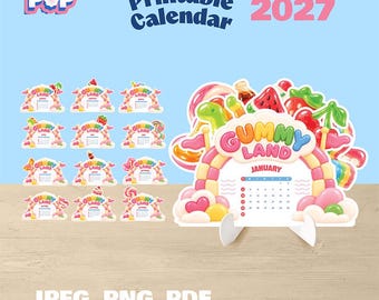 May include: A 2027 printable calendar set featuring twelve monthly cards with a Gummy Land theme. Each card displays a colorful candy-inspired arch, the text Gummy Land, and a monthly grid. A larger January card is displayed on a white stand.
