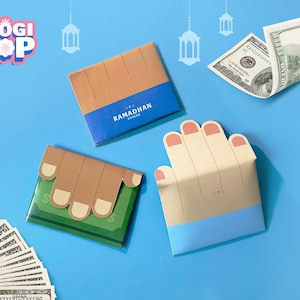 May include: A flat lay featuring paper wallets designed to resemble hands, holding dollar bills. The wallets are in various colors, including brown, blue, and green. The text "Ramadhan Kareem" is visible on one wallet. The background is a solid blue.