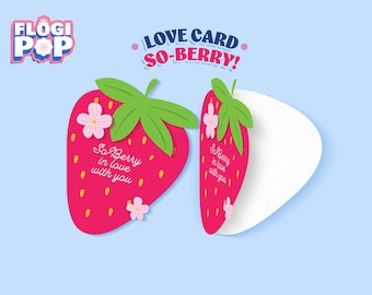 May include: A pair of strawberry-shaped love cards with the text "So Berry in love with you." The cards are red with green leaves and pink flower accents, set against a light blue background. The words "LOVE CARD SO-BERRY!" are at the top.