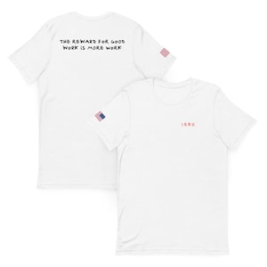 May include: Two white t-shirts. One shirt has the text "THE REWARD FOR GOOD WORK IS MORE WORK" on the back. The other shirt has "I.S.R.U." on the front. Both shirts have a small American flag on the sleeve.