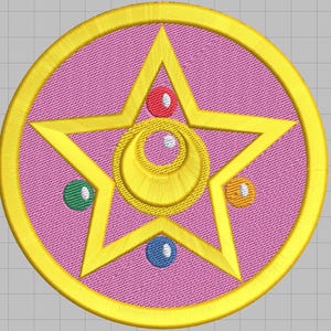 Könnte beinhalten: Gestickter Aufnäher mit einem goldenen Stern- und Halbmond-Design auf rosa Hintergrund. Der Stern ist von einem goldenen Kreis umgeben und mit roten, grünen, blauen und orangenen Perlen verziert. Geeignet für Kleidung oder Accessoires.