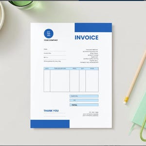 May include: A white invoice template with blue accents, featuring fields for company details, item descriptions, and totals. A pencil, keys, and a small notebook are next to the invoice. Grapes are in a white bowl.
