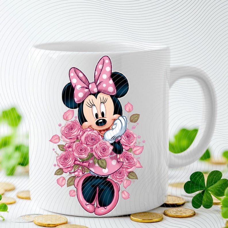 May include: White ceramic mug featuring a cartoon Minnie Mouse design. Minnie is depicted with a pink polka-dot bow, dress, and holding a bouquet of pink roses. The mug has a white handle and a curved design.