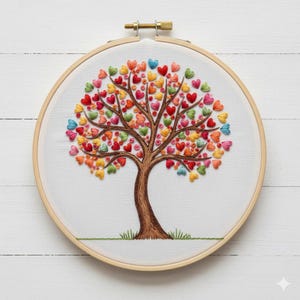 May include: Embroidered tree art in a wooden hoop. The tree trunk and branches are brown, with colorful heart-shaped leaves in shades of red, orange, yellow, green, and blue. The background is white, and the hoop is 8 inches in diameter.