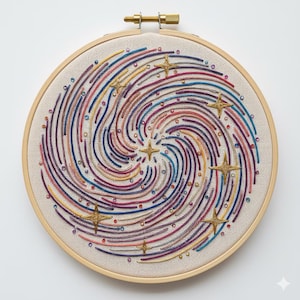 May include: Embroidered artwork in a wooden hoop. The design features a swirling galaxy pattern with colorful threads in shades of blue, red, yellow, and purple. Gold star accents are evenly spaced throughout the design.