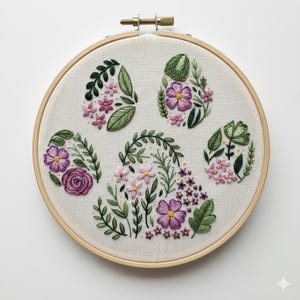 May include: A floral embroidery hoop featuring five embroidered floral designs. The designs include purple and pink flowers, green leaves, and stems. The embroidery is set against a cream-colored fabric, and the hoop is made of wood.