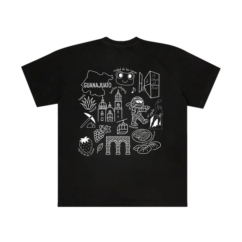Puede incluir: Camiseta negra con un dise&ntilde;o gr&aacute;fico blanco que presenta la palabra "GUANAJUATO" y varias ilustraciones. El dise&ntilde;o incluye un mapa, edificios y otros s&iacute;mbolos culturales. La camiseta est&aacute; hecha de un material suave.