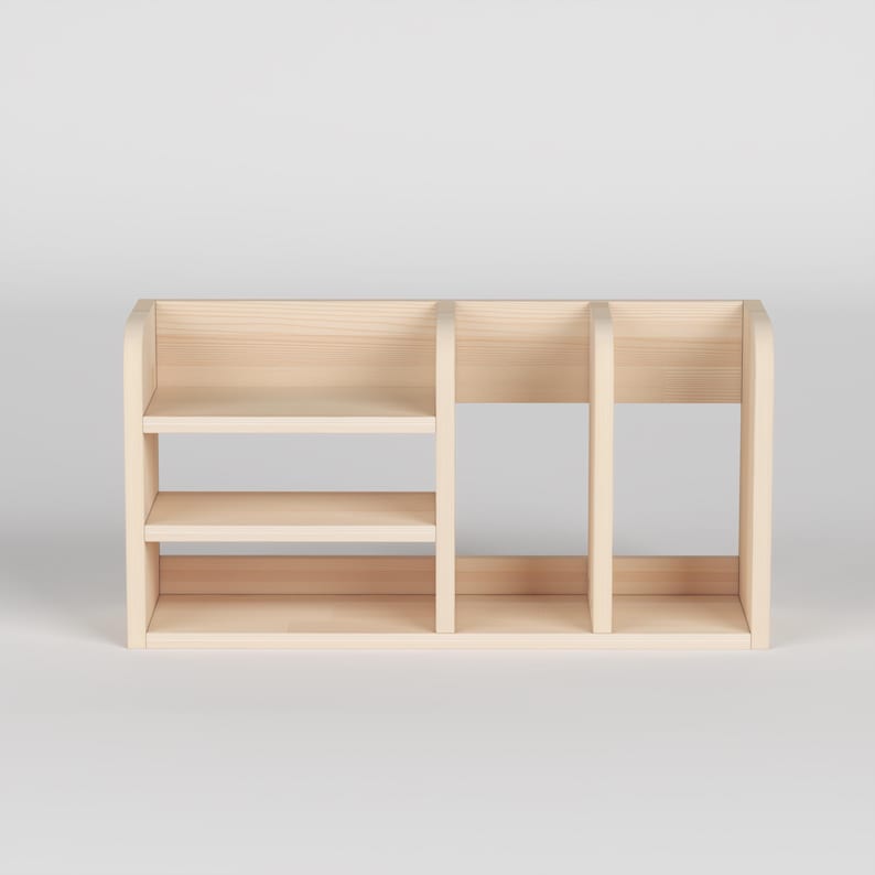 May include: A light-colored wooden desk organizer with three shelves and two vertical dividers. The organizer has a rectangular shape and is made of unfinished wood. The shelves are evenly spaced, providing storage for office supplies or small items.