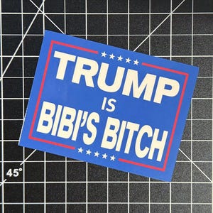 May include: A rectangular blue sticker featuring a red border and white text that reads TRUMP IS BIBI'S BITCH. The design includes five white stars above the text and five white stars below the text, arranged in a horizontal line on the blue background.