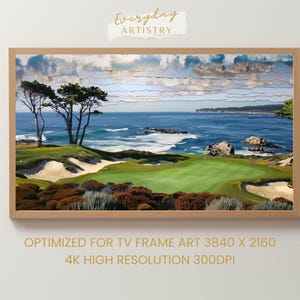May include: A framed landscape print depicting a golf course overlooking the sea. The artwork shows a green golf course, sandy bunkers, and the blue ocean under a cloudy sky. The frame is a light brown colour.