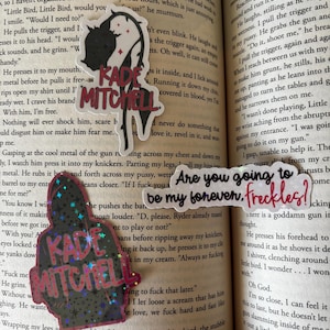 May include: A set of stickers featuring text and illustrations. One sticker reads "KADE MITCHELL" in red, another says "Are you going to be my forever. freckles?!" and a third shows a hooded figure with the name "KADE MITCHELL".